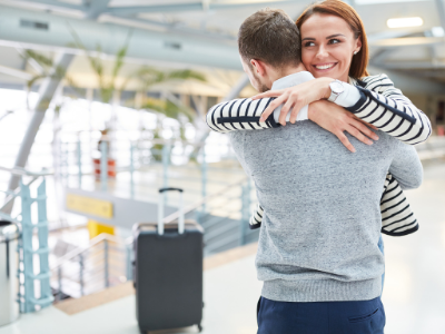 relationship visa australia - image of couple embracing at the airport - call HCM Legal today